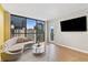 Bright living room features a curved sofa, city views from large windows, and modern decor at 1280 W Peachtree Nw St # 1712, Atlanta, GA 30309