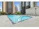 Outdoor pool with clear blue water surrounded by high-rise buildings, offering a city view at 1280 W Peachtree Nw St # 1712, Atlanta, GA 30309