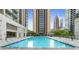 Rooftop swimming pool with lounge chairs and a beautiful view of the city skyline at 1280 W Peachtree Nw St # 1712, Atlanta, GA 30309