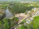 Expansive aerial view highlighting the pond, community pool, tennis and basketball courts, and residential neighborhood at 2061 Emerald Dr, Loganville, GA 30052