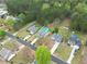 Aerial view of home featuring a refreshing swimming pool, well-manicured lawn, and charming neighborhood at 2061 Emerald Dr, Loganville, GA 30052