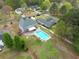 Aerial view of home featuring a refreshing swimming pool, well-manicured lawn, and charming neighborhood at 2061 Emerald Dr, Loganville, GA 30052