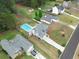 Aerial view of home featuring a refreshing swimming pool, well-manicured lawn, and charming neighborhood at 2061 Emerald Dr, Loganville, GA 30052