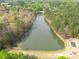 Picturesque aerial view featuring a serene pond surrounded by lush trees and community amenities at 2061 Emerald Dr, Loganville, GA 30052