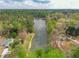 Scenic aerial view of the pond surrounded by lush greenery and residential houses creating a private oasis at 2061 Emerald Dr, Loganville, GA 30052