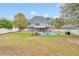 Spacious backyard featuring a refreshing in-ground pool, lounge chairs, and covered patio at 2061 Emerald Dr, Loganville, GA 30052
