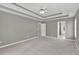 Open primary bedroom with trey ceilings, and a view into the bathroom with a separate water closet at 2061 Emerald Dr, Loganville, GA 30052