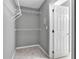 Bright walk-in closet with carpet flooring, wire racks, and a door leading to the bedroom at 2061 Emerald Dr, Loganville, GA 30052