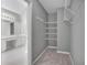 Walk-in closet next to the bathroom with built-in shelves and clothing racks for organized storage at 2061 Emerald Dr, Loganville, GA 30052