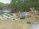 Aerial view of the community pool area surrounded by lush greenery with a nearby recreation center at 2061 Emerald Dr, Loganville, GA 30052