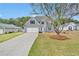 Charming two-story home with gray siding, attached garage, and well-manicured front lawn at 2061 Emerald Dr, Loganville, GA 30052