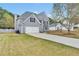 Charming two-story home with gray siding, attached garage, and long driveway at 2061 Emerald Dr, Loganville, GA 30052