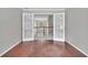 Hallway with hardwood floors and double doors with glass inserts at 2061 Emerald Dr, Loganville, GA 30052