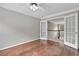 Hallway with hardwood floors and double doors with glass inserts at 2061 Emerald Dr, Loganville, GA 30052