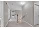Carpeted hallway with white trim and doors to other rooms at 2061 Emerald Dr, Loganville, GA 30052