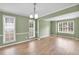 Spacious living room filled with natural light, featuring elegant hardwood floors and neutral color palette at 2061 Emerald Dr, Loganville, GA 30052