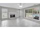 Sunlit living room with charming fireplace and pool views from expansive windows at 2061 Emerald Dr, Loganville, GA 30052