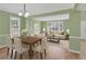 Bright, open-concept living and dining area with hardwood floors, modern lighting, and neutral decor at 2061 Emerald Dr, Loganville, GA 30052