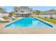 Large, in-ground backyard pool with a view of the home and fence at 2061 Emerald Dr, Loganville, GA 30052