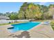 Backyard pool with steps for entry and an expansive concrete patio at 2061 Emerald Dr, Loganville, GA 30052