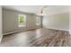 Spacious bedroom with ceiling fan, two windows, and beautiful wood-look flooring at 3267 Forrest Bluff Way, Lithonia, GA 30038