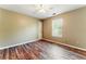 Comfortable bedroom with wood-look floors, neutral walls, and ample natural light at 3267 Forrest Bluff Way, Lithonia, GA 30038