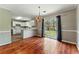 Open dining area with wood floors, chandelier and sliding glass doors at 3267 Forrest Bluff Way, Lithonia, GA 30038