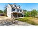 Exterior of home with wide driveway, stone facade, and covered porch at 3267 Forrest Bluff Way, Lithonia, GA 30038