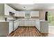 Bright kitchen with white cabinets, countertops, and stainless steel appliances at 3267 Forrest Bluff Way, Lithonia, GA 30038