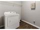 Practical laundry room featuring a white dryer, shelving, and wood-look flooring at 3267 Forrest Bluff Way, Lithonia, GA 30038