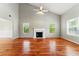 Bright living room featuring a vaulted ceiling, fireplace, and hardwood floors at 3267 Forrest Bluff Way, Lithonia, GA 30038