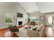 Stylishly furnished living room with fireplace, vaulted ceiling, and hardwood floors at 3267 Forrest Bluff Way, Lithonia, GA 30038