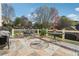 The backyard offers an expansive stone patio, with multiple tables and seating areas at 405 N Pine Dr, Alpharetta, GA 30022