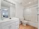 A clean bathroom features a vanity, toilet and shower-tub combination with sliding glass door at 405 N Pine Dr, Alpharetta, GA 30022