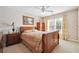 Comfortable bedroom with a ceiling fan, natural light, and classic wooden furniture at 405 N Pine Dr, Alpharetta, GA 30022