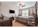 Spacious bedroom with a ceiling fan, mounted TV, and large windows at 405 N Pine Dr, Alpharetta, GA 30022