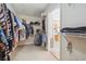 Walk-in closet filled with clothes and shelving, leading to a view of the bathroom at 405 N Pine Dr, Alpharetta, GA 30022