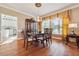 Elegant dining room featuring hardwood floors, a chandelier, and a hutch for storage at 405 N Pine Dr, Alpharetta, GA 30022