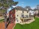 Two-story home featuring a large deck and well-maintained lawn at 405 N Pine Dr, Alpharetta, GA 30022