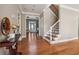 Spacious foyer with hardwood floors, staircase, and clear view into the home's interior at 405 N Pine Dr, Alpharetta, GA 30022