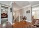 Hallway with hardwood floors, chandelier, iron stairway, and doorway views of bedrooms at 405 N Pine Dr, Alpharetta, GA 30022