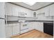 The kitchen includes wooden-look floors, white cabinets, and a sink with black appliances at 405 N Pine Dr, Alpharetta, GA 30022