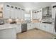 Modern kitchen with stainless steel appliances, white cabinets, and sleek countertops at 405 N Pine Dr, Alpharetta, GA 30022