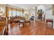 Open-concept living room with hardwood floors, detailed furniture, and elegant decor at 405 N Pine Dr, Alpharetta, GA 30022