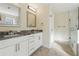 Bathroom featuring double sink vanity with granite countertop and a glass enclosed shower at 7902 West Shore Cir, Riverdale, GA 30296
