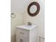 Cozy bathroom featuring a single vanity with marble countertop and decorative mirror, creating a welcoming space at 7902 West Shore Cir, Riverdale, GA 30296