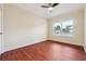 Bedroom with hardwood floors, neutral paint, two windows and a ceiling fan for a bright and airy feel at 7902 West Shore Cir, Riverdale, GA 30296