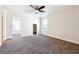 Bedroom with neutral carpet, ceiling fan, and walk-in closet access at 7902 West Shore Cir, Riverdale, GA 30296