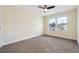 Cozy bedroom with neutral carpet, neutral paint and two windows with natural light and a ceiling fan at 7902 West Shore Cir, Riverdale, GA 30296