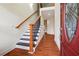 Inviting foyer with hardwood floors, staircase, and front door with decorative glass at 7902 West Shore Cir, Riverdale, GA 30296